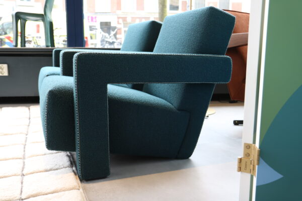 Utrecht chair van Cassina in petrol blauwe bouclé. Deze design klassieker is direct verkrijgbaar tegen een scherpe prijs bij Hartman Binnenhuisadviseurs.
